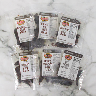 Assorted packages of beef jerky on a marble surface